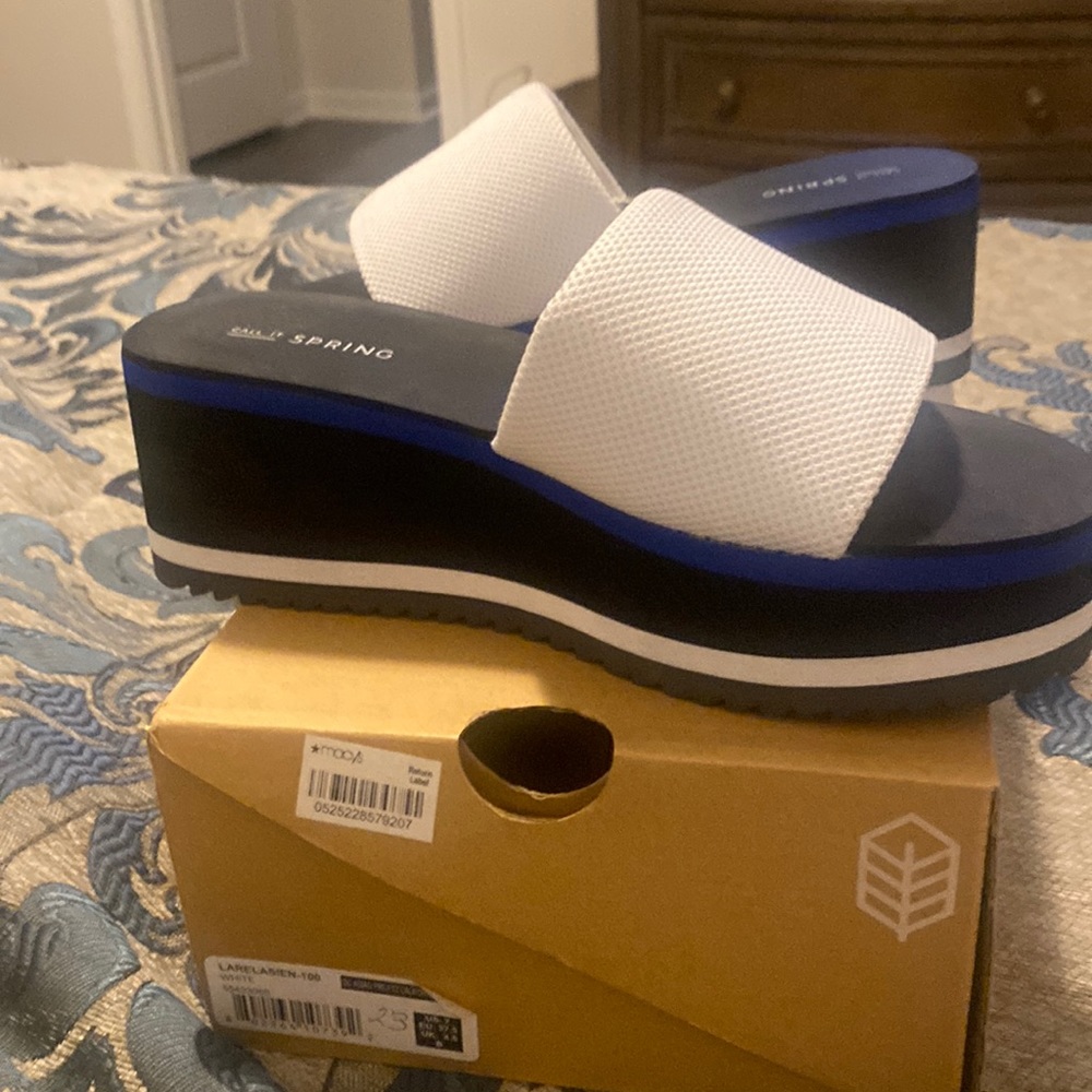 White slides trimmed in blue, white and black